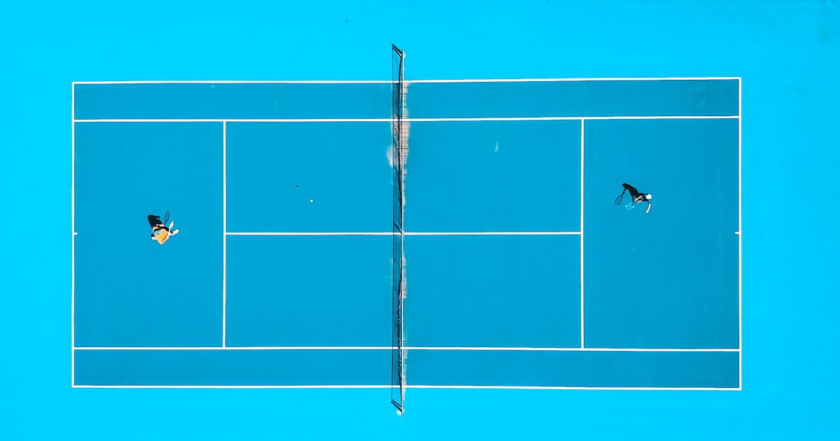 Aerial photo of two people playing pickleball on a court