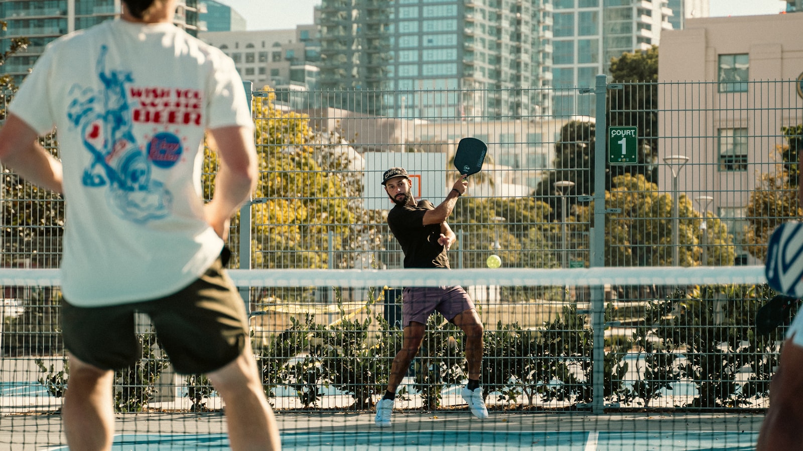 A group of pickleball players standing together on a court, paddles in hand, like a team lineup between ties