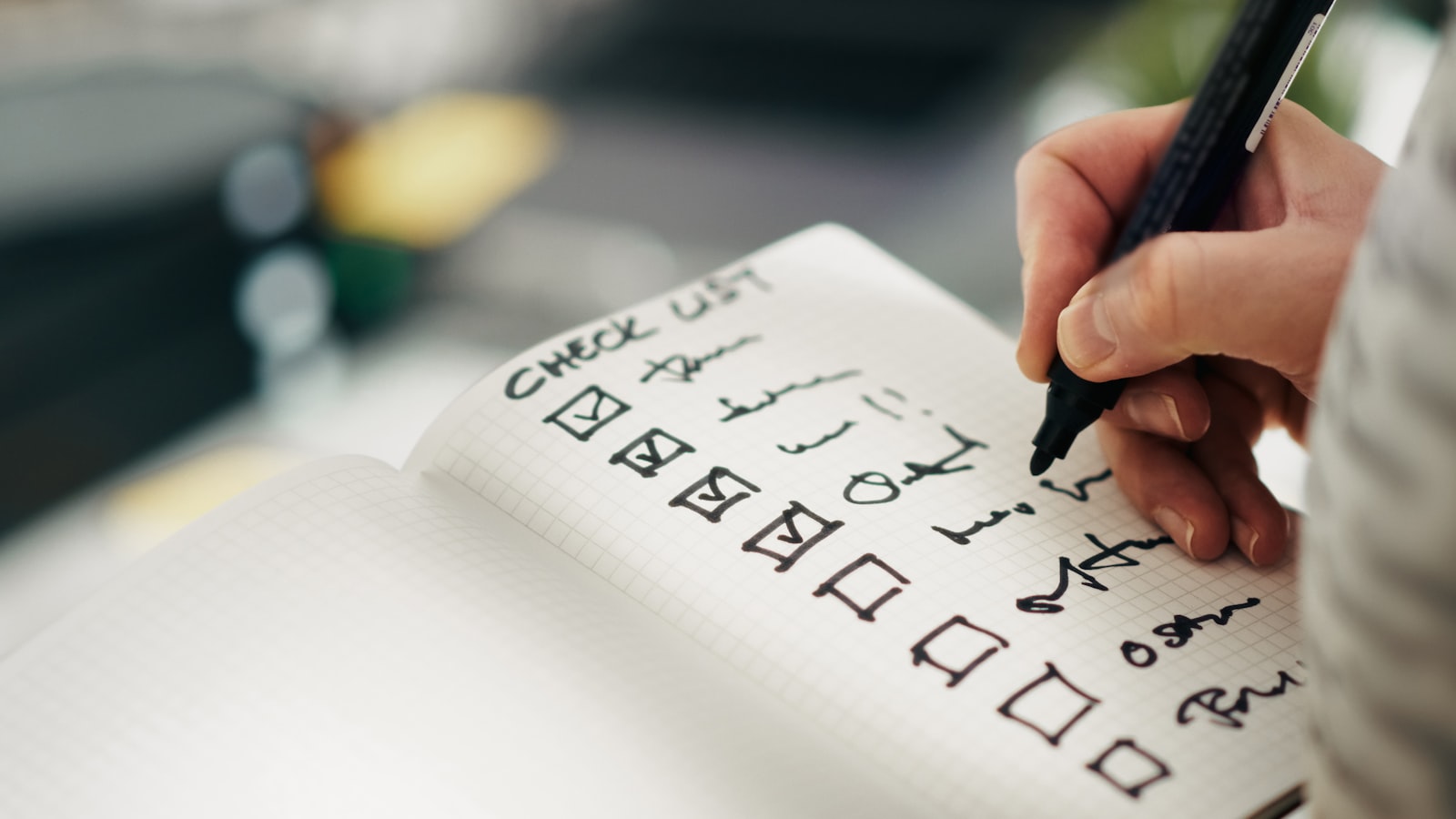 Someone checking items off a printed checklist